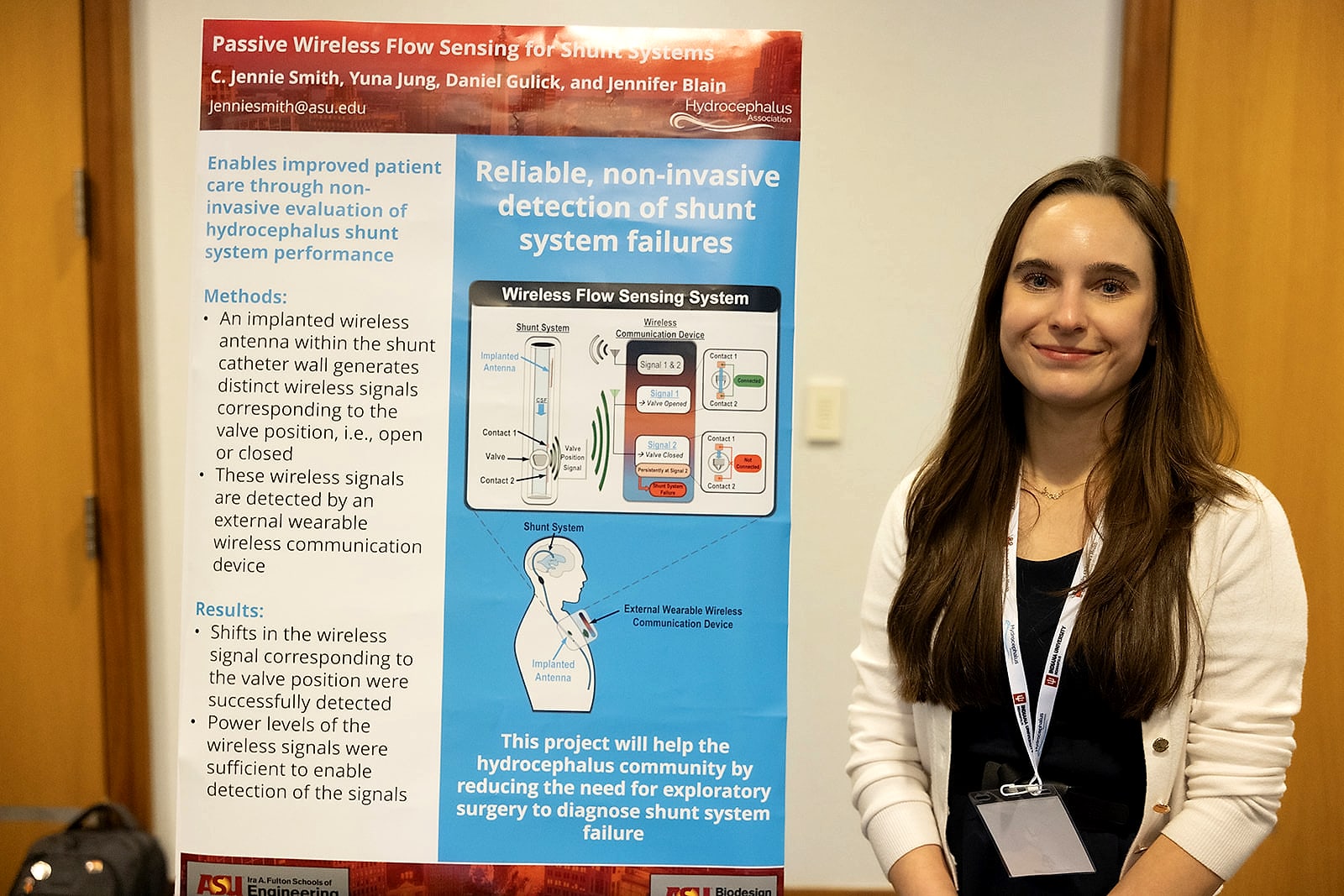 A young researcher beside her poster on reliable, non-invasive detection of shunt failure
